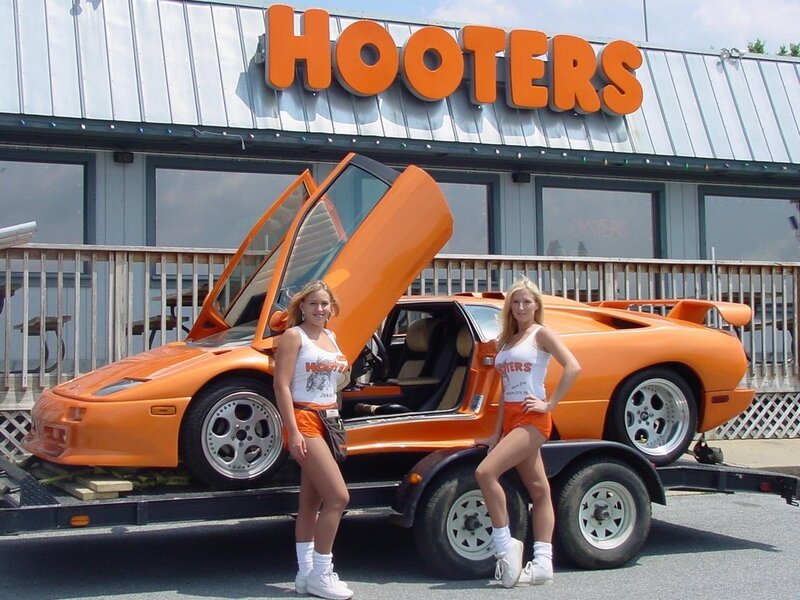Hooters models with orange car
