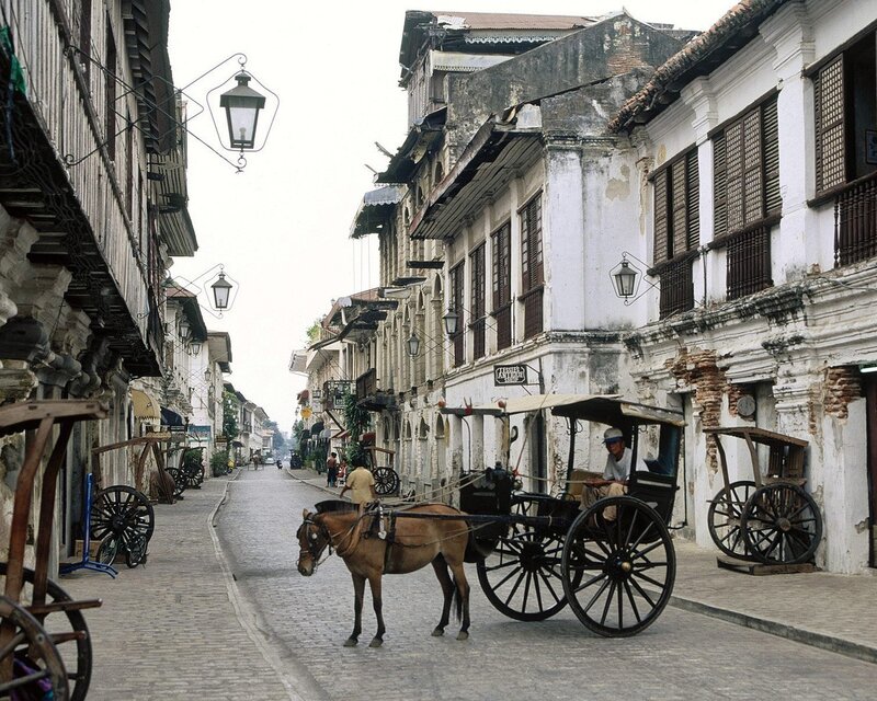 Horse-drawn carriage on cobblestone street