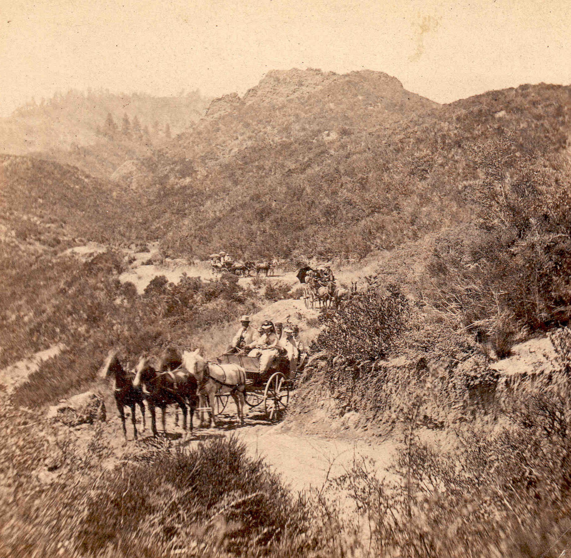 Horse-drawn carriages on a mountain path
