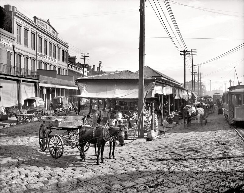 Horse-drawn carts on a cobblestone street