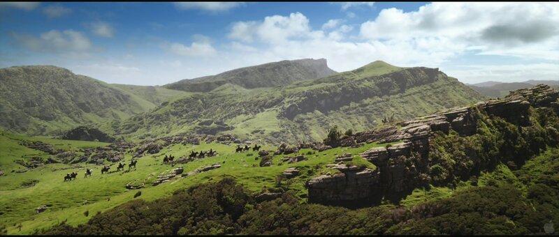 Horse riders in a green valley