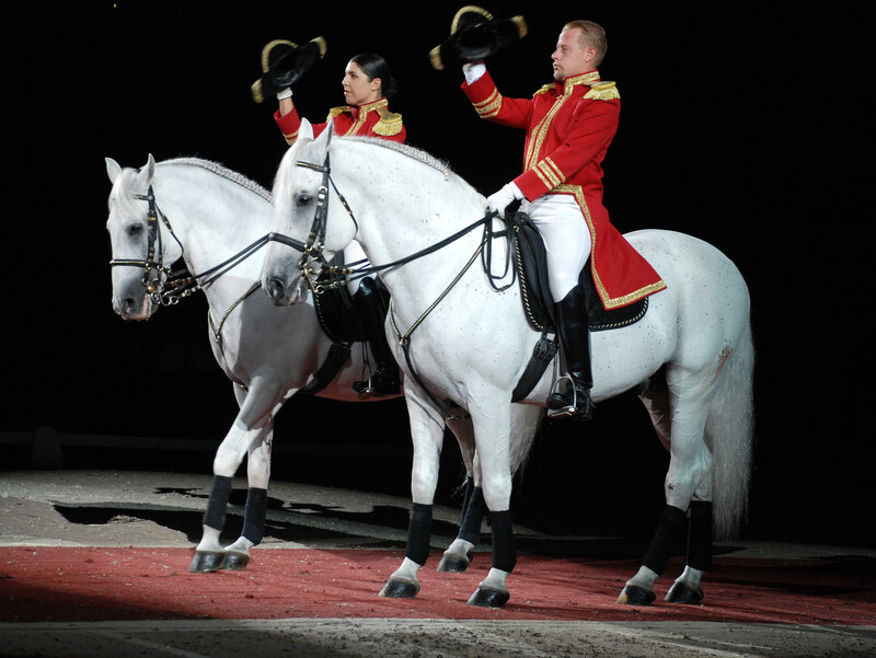 Horse riders in red uniforms