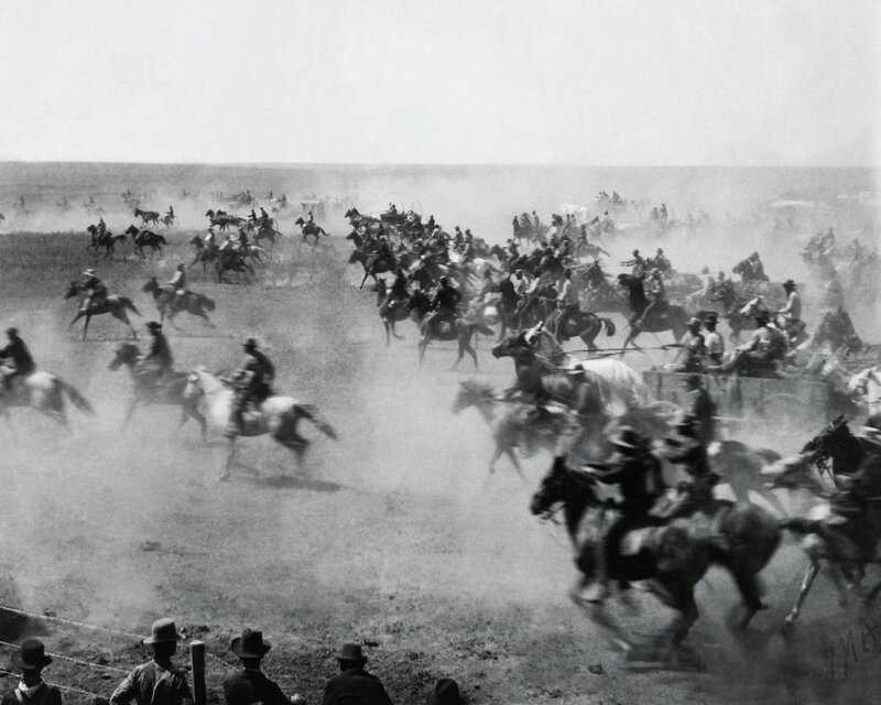 Horseback riders in a dusty field