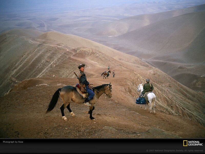 Horseback riders in mountainous terrain