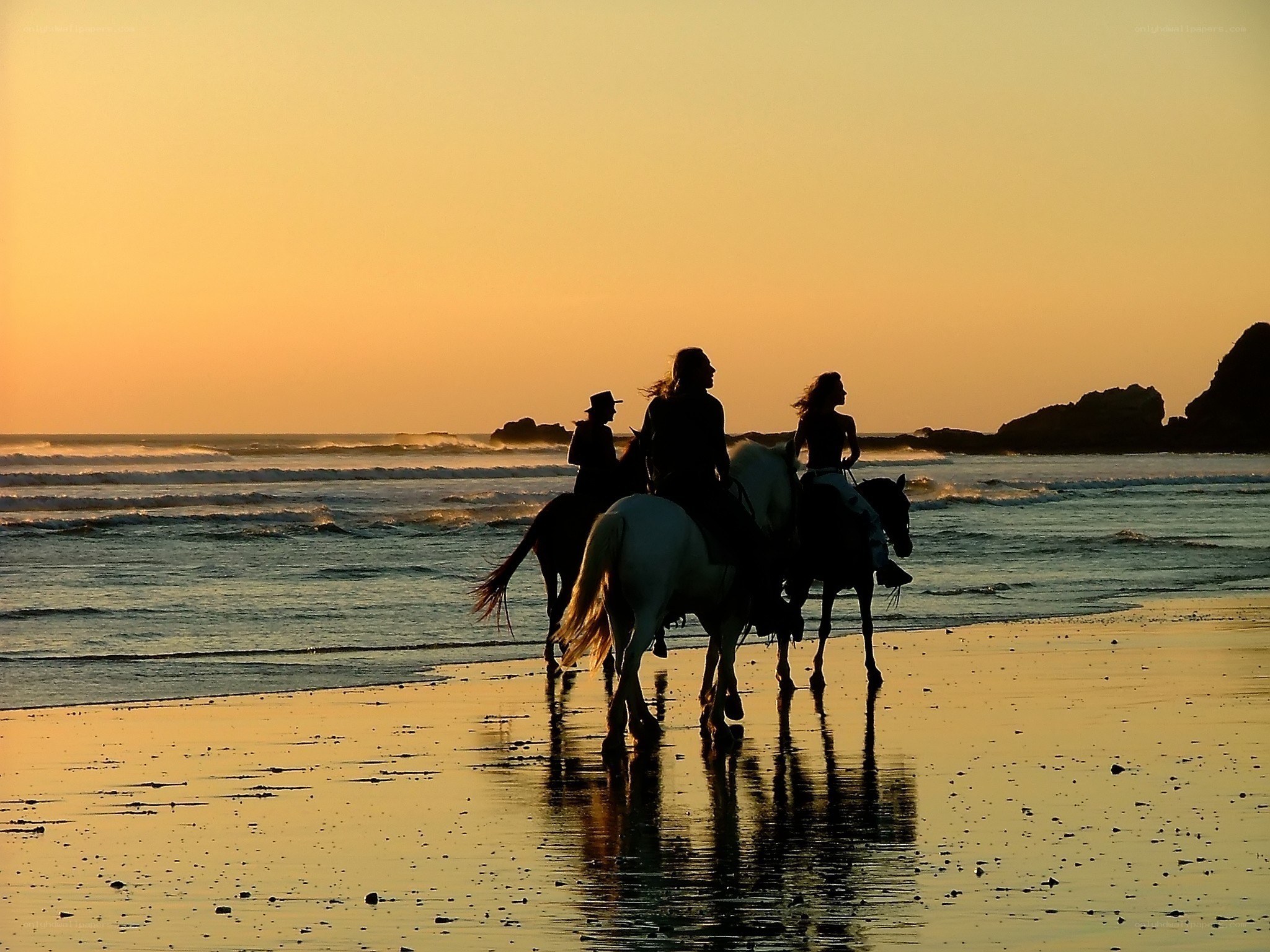 Horseback riders on the beach