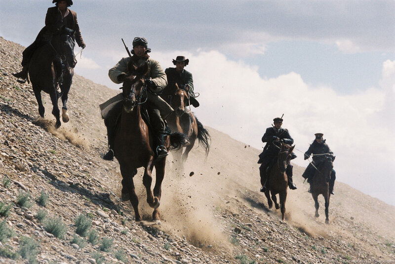 Horsemen riding up a hill