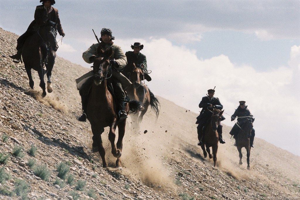 Horsemen riding up a hill