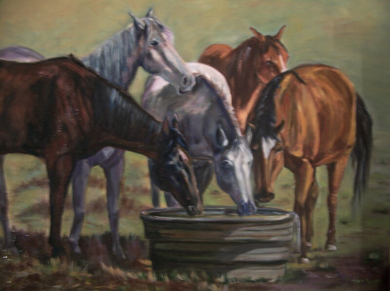 horses drinking from a trough