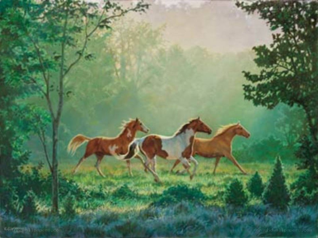 Horses running in a forest