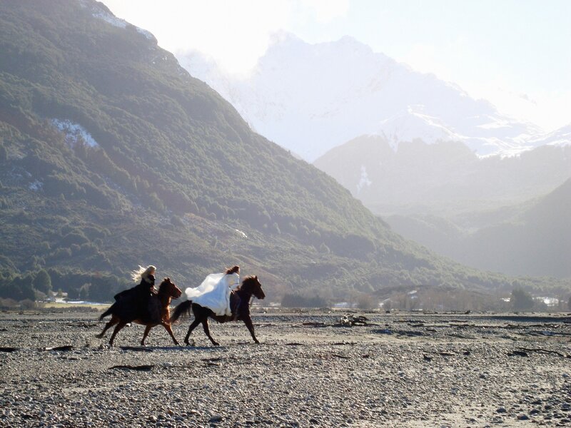 Horses running on a riverbed