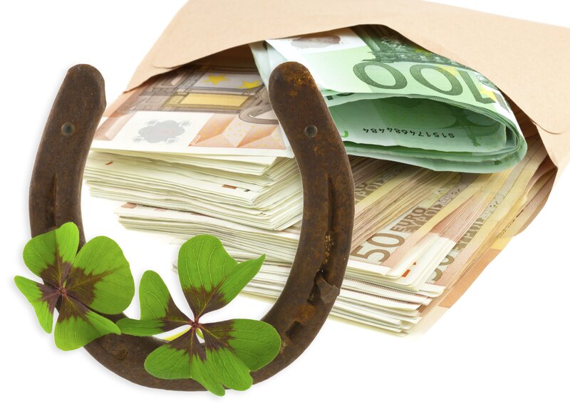 Horseshoe with clovers and money