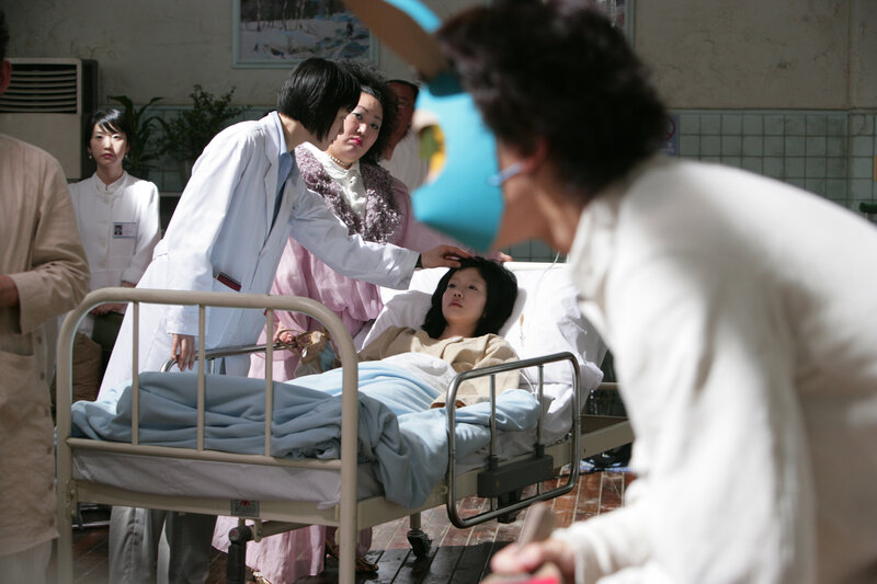 Hospital scene with patient and doctors