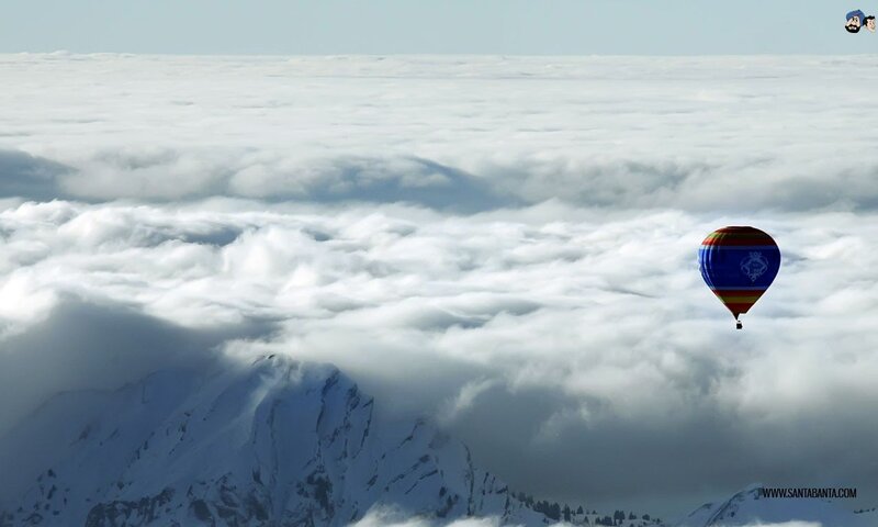 Hot air balloon above clouds
