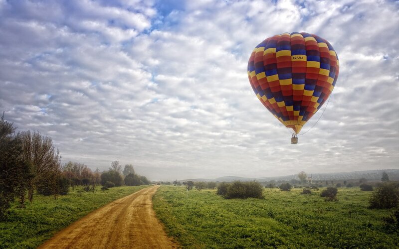 Hot air balloon over a country road