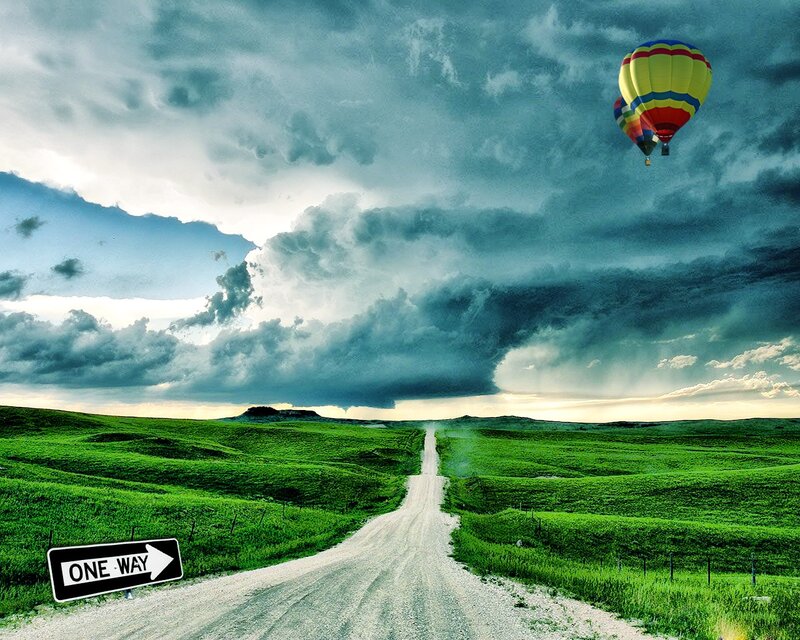 Hot air balloon over a rural road