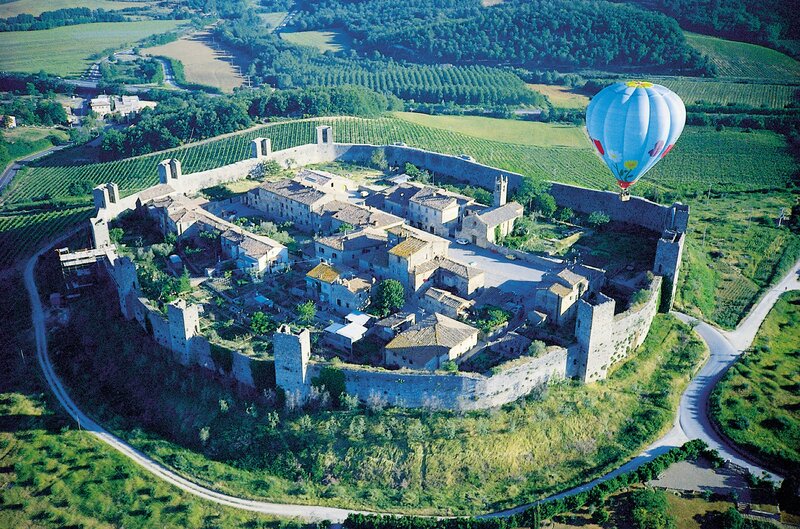 Hot air balloon over a walled village