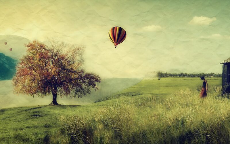 Hot air balloon over autumn field