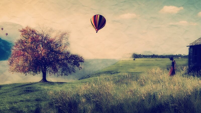 Hot air balloon over autumn field