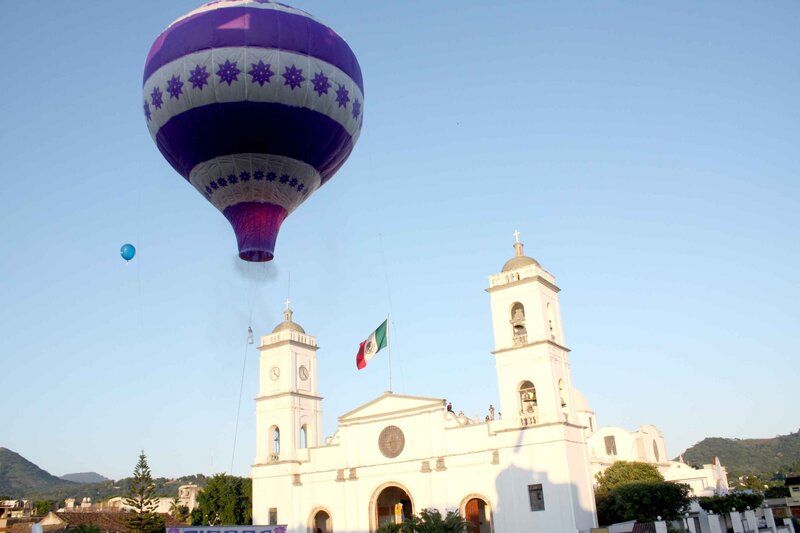 Hot air balloon over church