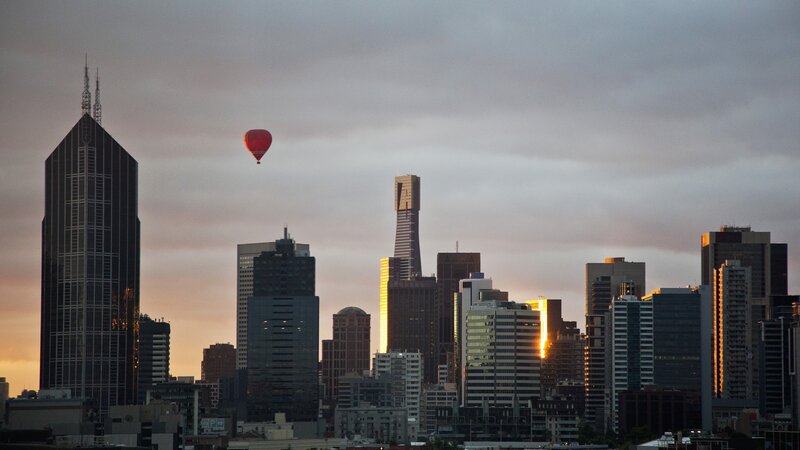 Hot Air Balloon over City — Gray, Serene, Sunset