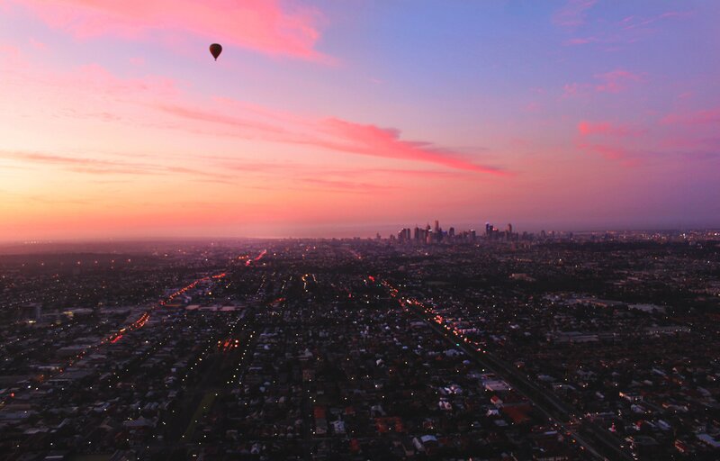Hot Air Balloon over City — Pink