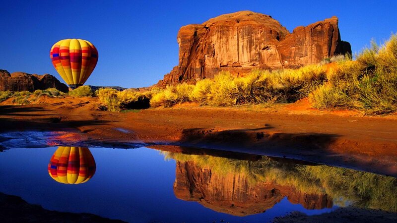 Hot air balloon over desert canyon