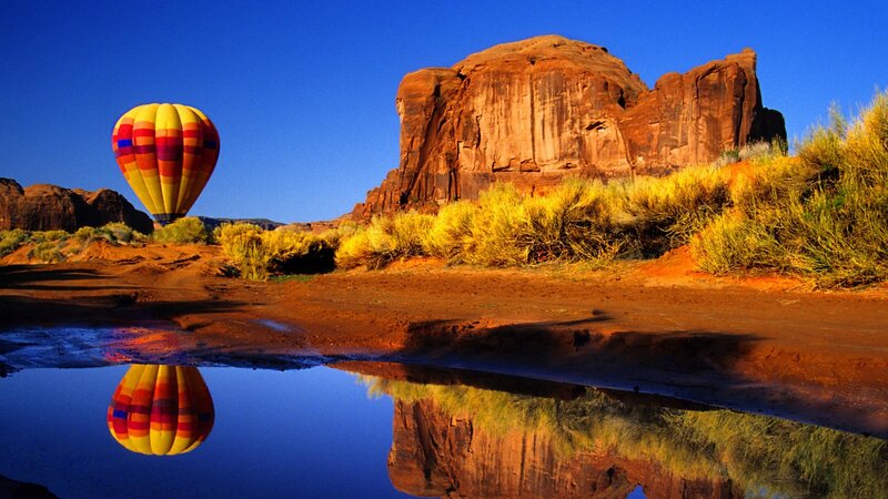 Hot air balloon over desert canyon
