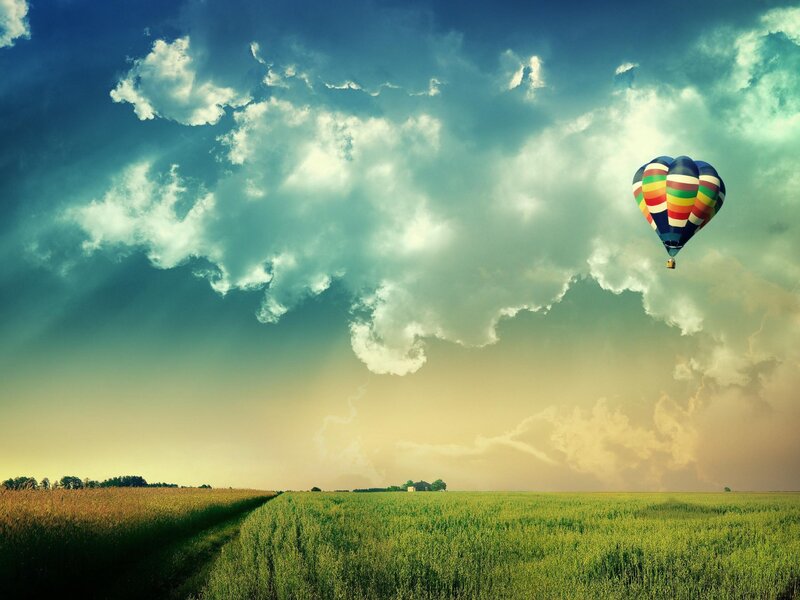 Hot air balloon over fields