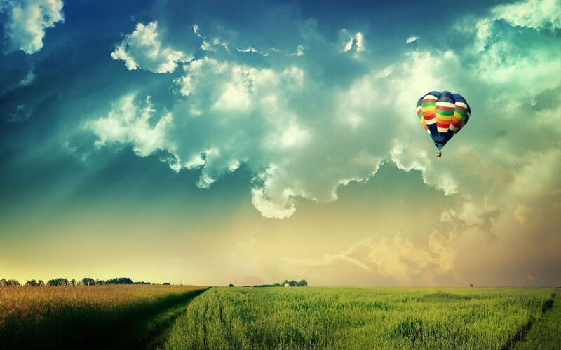 Hot air balloon over fields