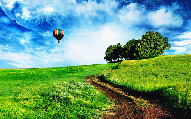Hot air balloon over green hills