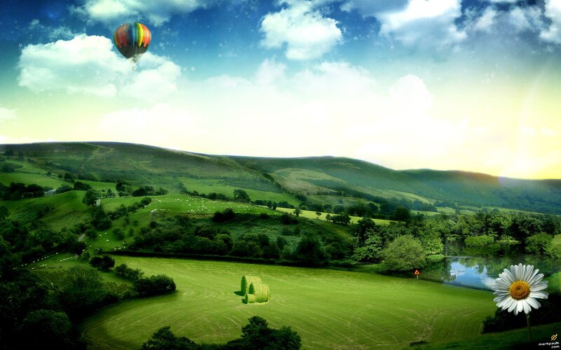 Hot air balloon over green hills