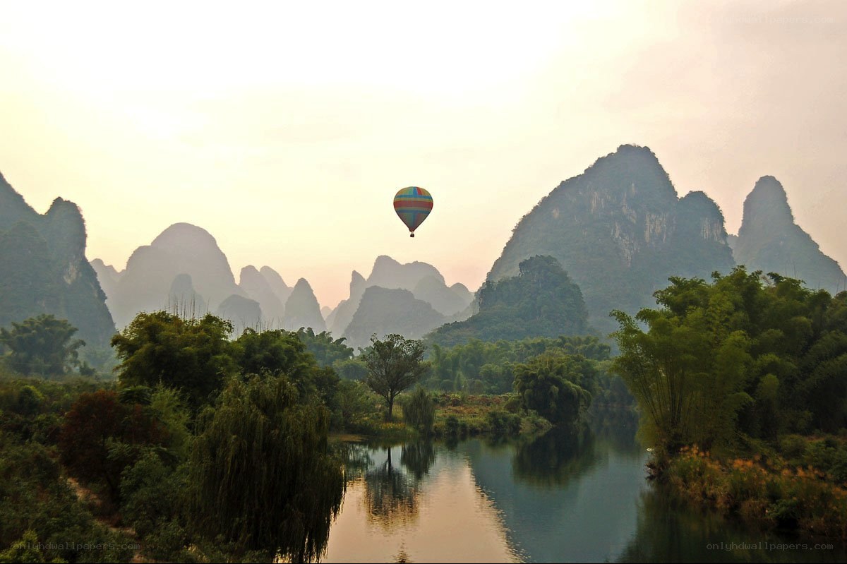 Hot air balloon over karst landscape