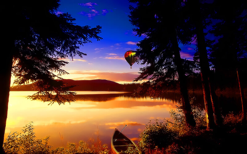 Hot air balloon over lake at sunset