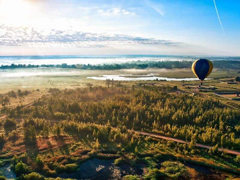 Hot air balloon over misty landscape