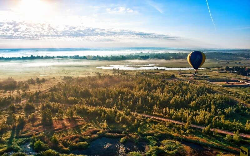 Hot air balloon over misty landscape