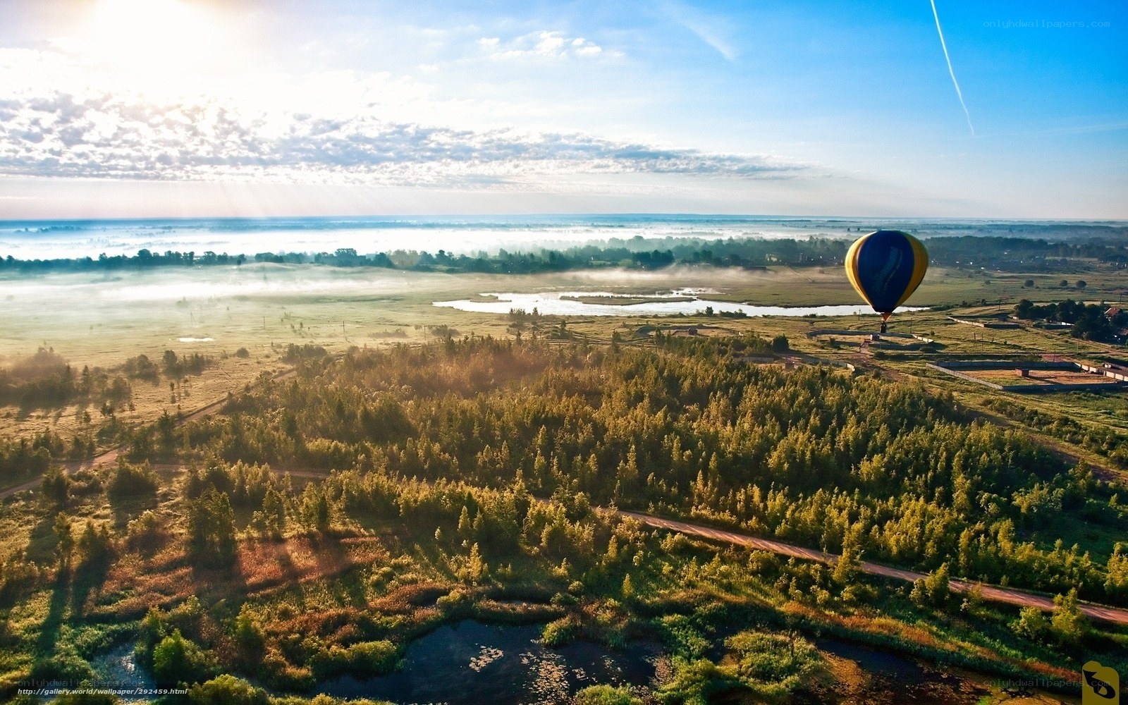 Hot air balloon over misty landscape