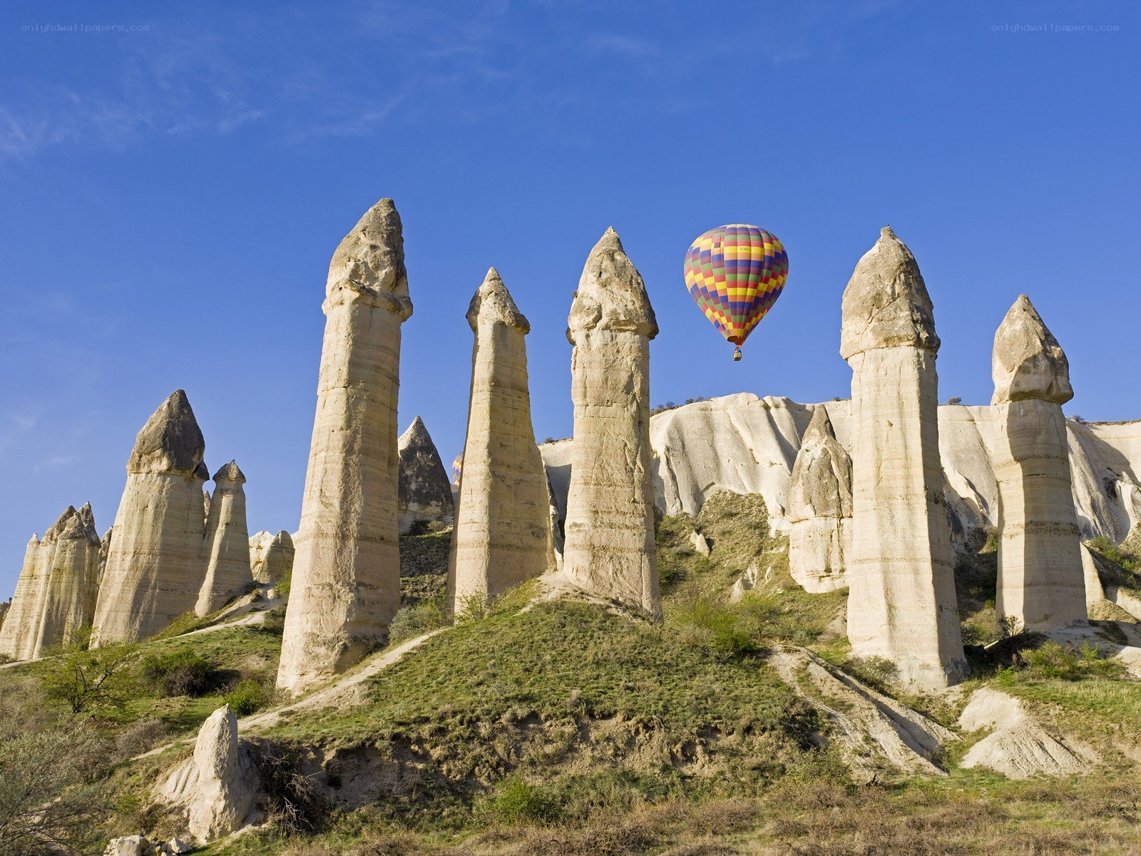 Hot air balloon over rock formations