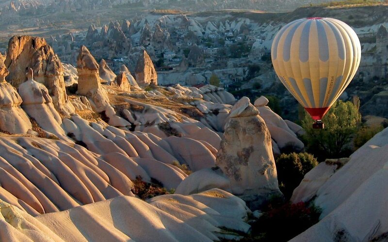 Hot Air Balloon over Rock Formations — Beige, Serene