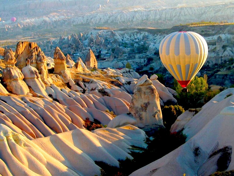 Hot Air Balloon over Rock Formations — White, Serene
