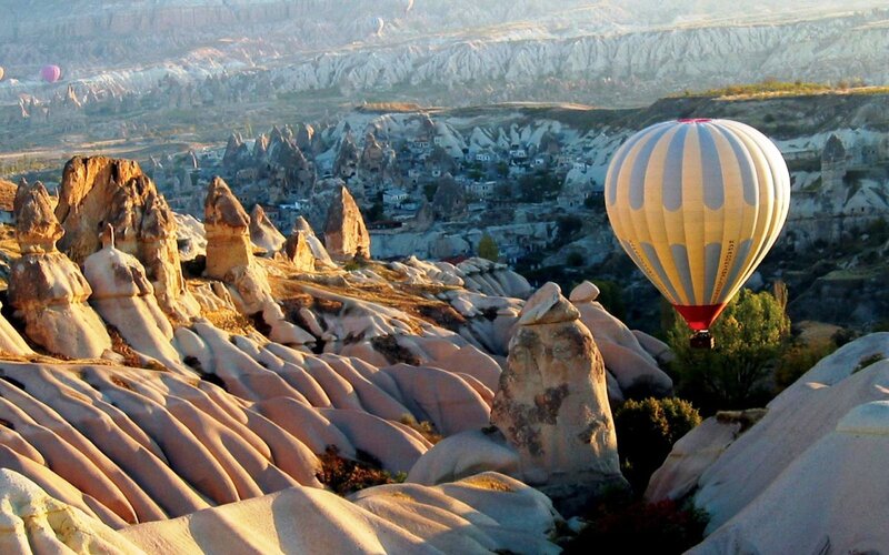 Hot Air Balloon over Rock Formations — White