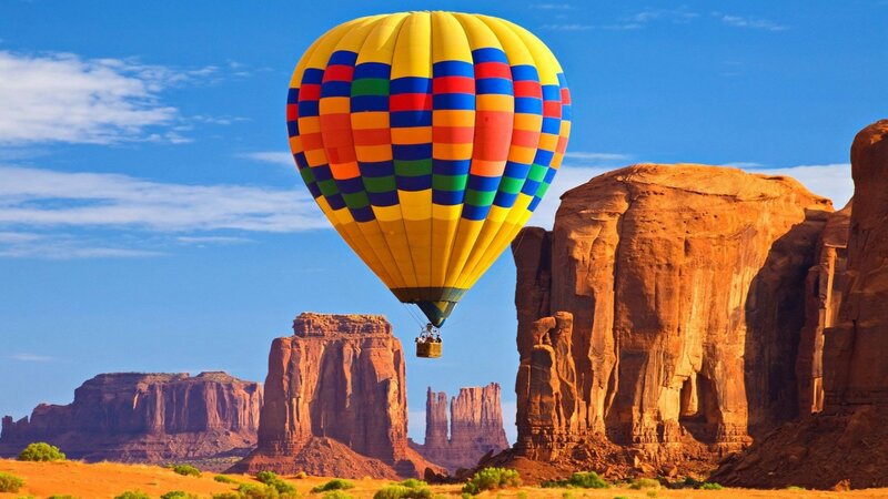 Hot Air Balloon over Rock Formations — Yellow, Serene