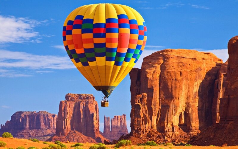 Hot Air Balloon over Rock Formations — Yellow