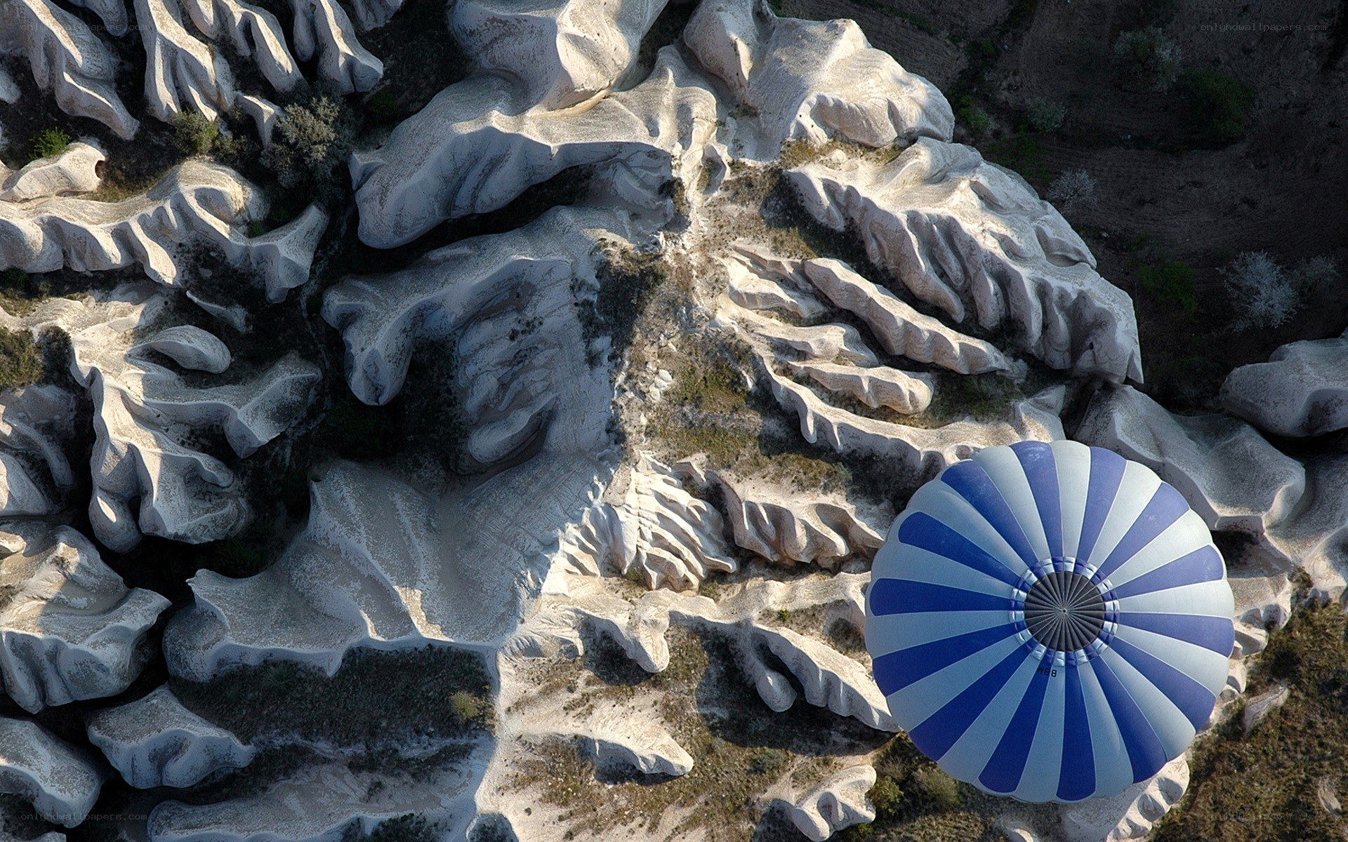 Hot air balloon over rock formations