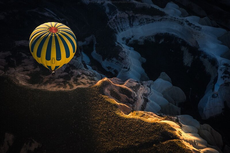 Hot air balloon over rocky landscape