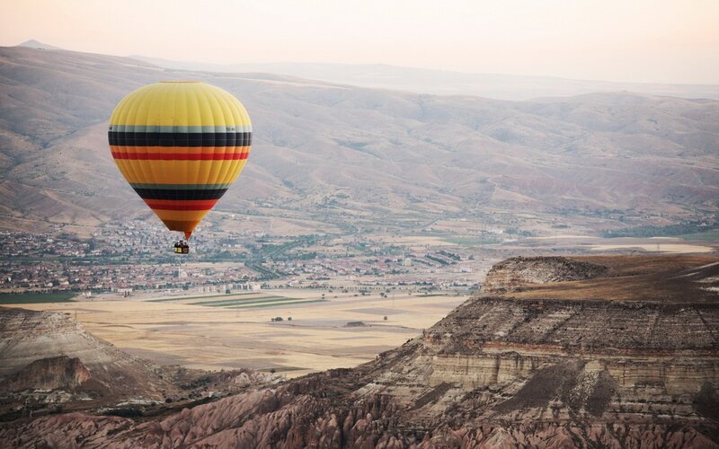 Hot Air Balloon over Valley — Yellow