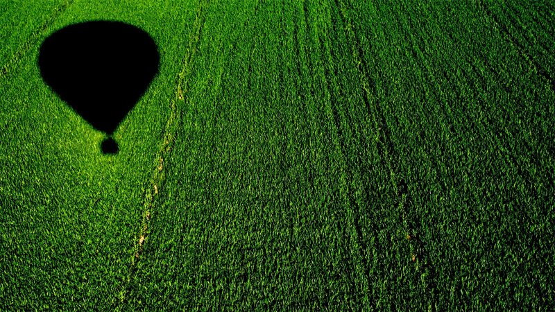 hot air balloon shadow on field