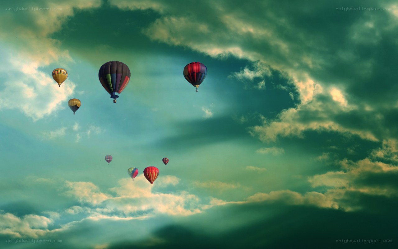 Hot air balloons in cloudy sky