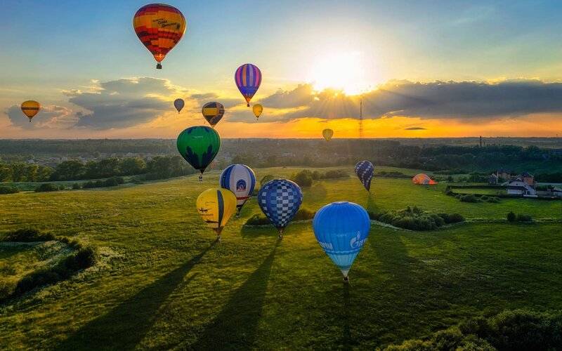 Hot Air Balloons in Field — Green, Serene, Sunrise