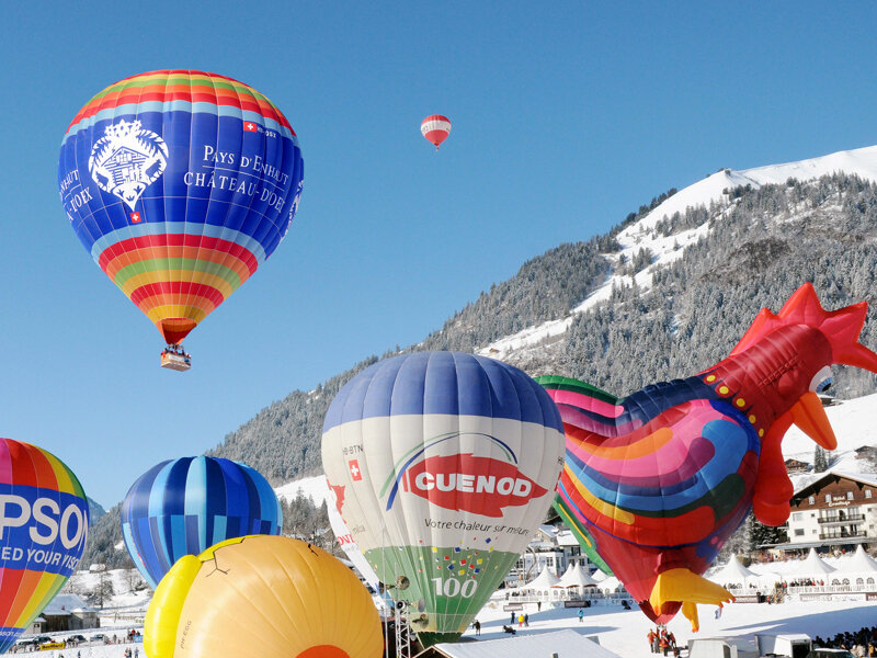 Hot air balloons in snowy mountains