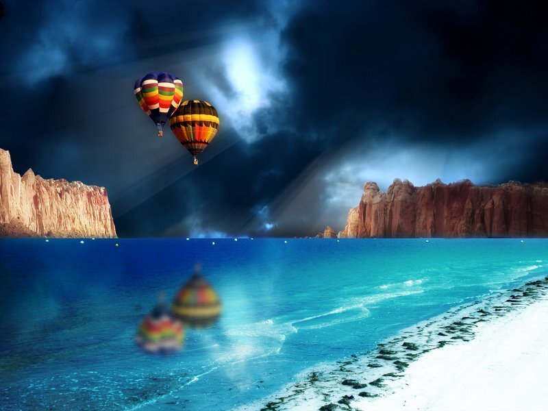 Hot air balloons over a coastal landscape